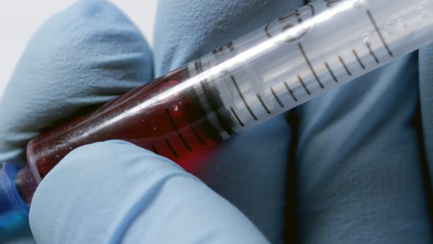 Drawing blood into syringe