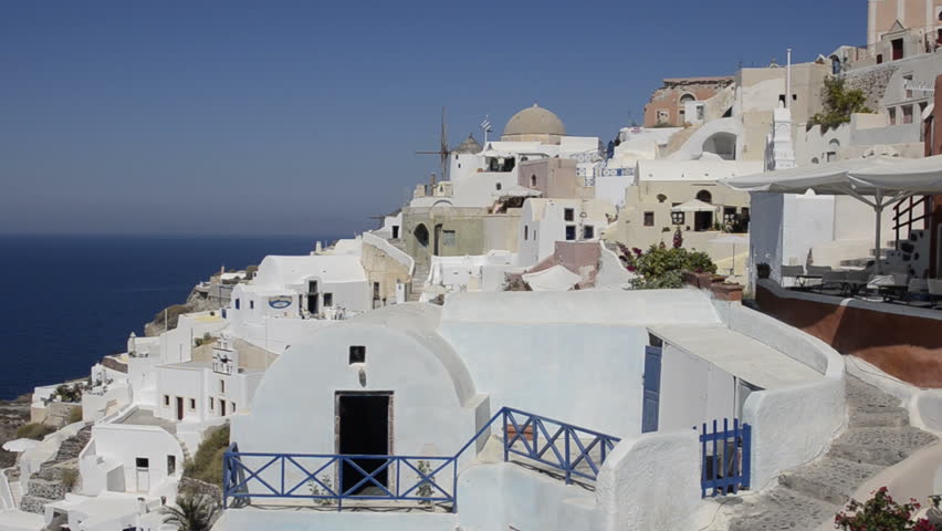 Santorini Greece and the beautiful white buildings on the mountain cliffs of the small isolated romantic city of Oia
