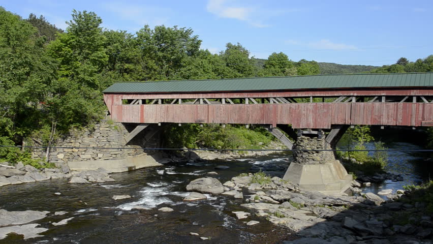 Old historic red old Covered Bridge over the river in Taftsville Vermont