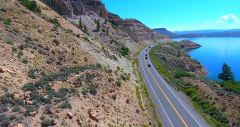 Cars & Camper Van Driving On Mountain Highway Overlooking Large Blue Lake - Colorado, USA