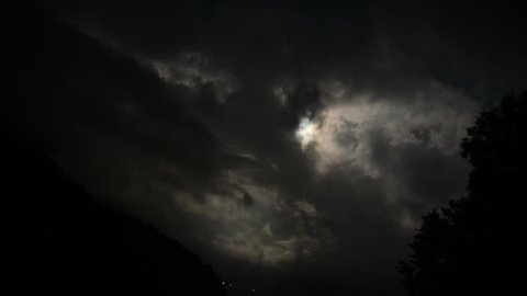 Time lapse of Moon Rolling Over Beautiful Clouds in Swiss Alps
