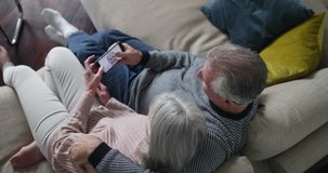 Senior couple looking at photo of daughter on a smartphone