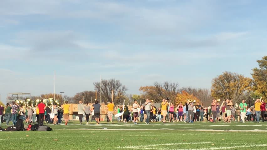 FARGO, ND - OCTOBER, 20, 2017:  Marching band practice outside in late afternoon sunshine to rehearse program a day before event.  