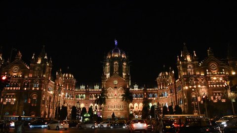 MUMBAI, INDIA, 2 DECEMBER 2016 : Busy traffic in front of Chhatrapati Shivaji Terminus or Victoria Terminus at night, It is UNESCO World Heritage Site and an historic railway station in Mumbai
