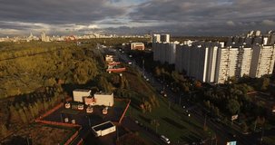 4K high quality aerial video urban cityscape view of Krylatskoye residential suburb, roads, park, power station smoking chimney and river view on sunny afternoon near Moscow River in Moscow, Russia