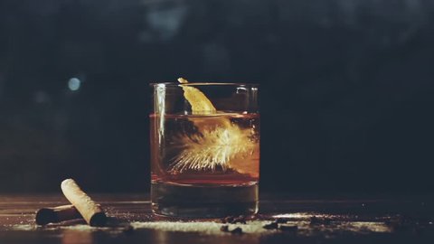 Alcohol cocktail with ice cubes on bar