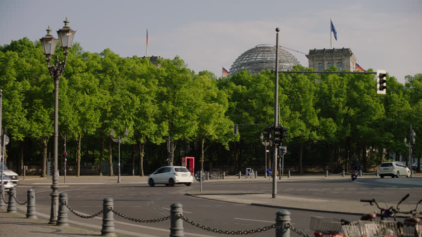 May, 2017 Berlin, Germany. Pan from Reichstag side with street traffic to back of the Brandenburg Gate in the early morning.