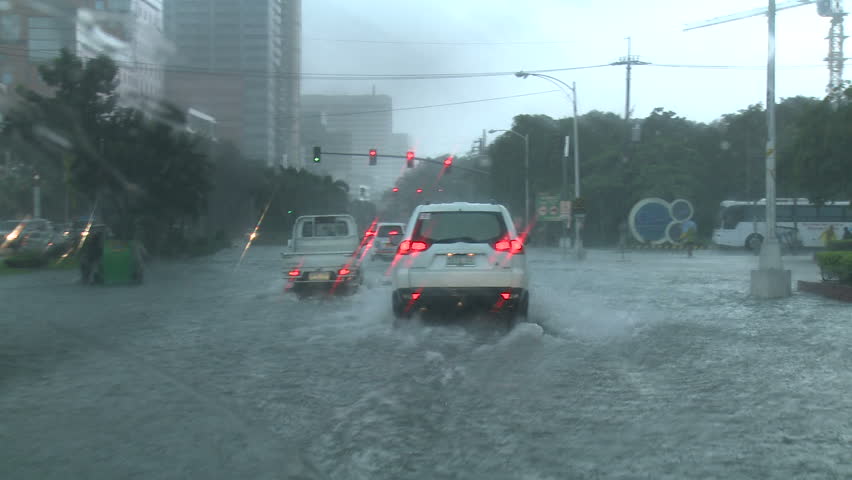 MANILA, PHILIPPINES - CIRCA AUGUST 2012: Driving In Flooded Road Tropical Storm.