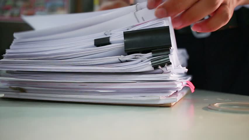 Businessman searching documents files or information in Stack of papers folder on work in office, Business report paper or piles of unfinished document achieves with clips on offices, Business concept | Shutterstock HD Video #32338408
