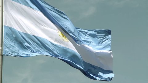 Giant Argentinian Flag Waving Against Blue Sky.