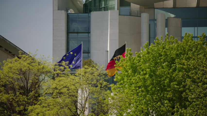 May, 2017 Berlin, Germany. The German Chancellery Building EU and German Flags waving.