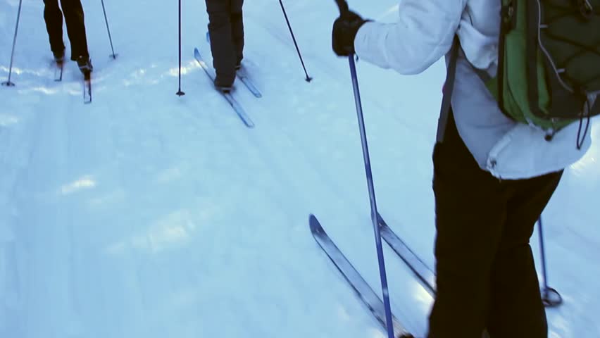 a group cross country skiing across the snow