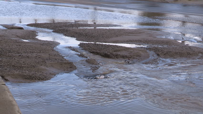 Toronto, Ontario, Canada October 2017 City street decaying infrastructure and broken watermain causing flooding