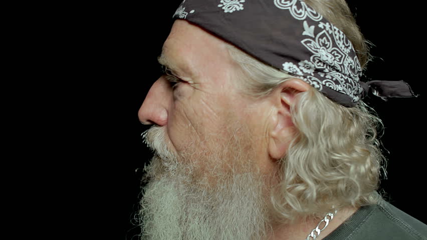 Mature Biker turning and laughing like a crazy man.