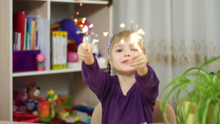 Child with sparklers at home