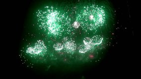 Firework display at night on black background. Bright red green yellow explosions. Amazingly beautiful. Salute for new year, Christmas and other holidays. Macro video closeup footage 50p.