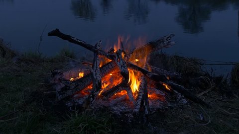 Campfire near water. River evening time
