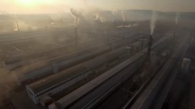 Flight in smoke giant heavy industry factory. Large shops. Modern metal production. High tubes dust dirt pollution. Aerial drone cinematic 4k footage.