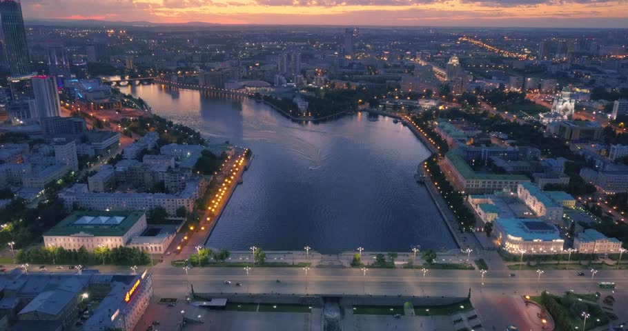 Aerial view of Yekaterinburg city center featuring Iset river bank and Lenina Street traffic at sunset. Ural region, Russia. 4K UHD.