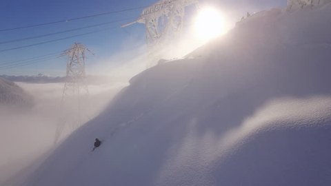 Epic Backcountry Snowboard Jump Aerial with Sun Rays in Fog Haze