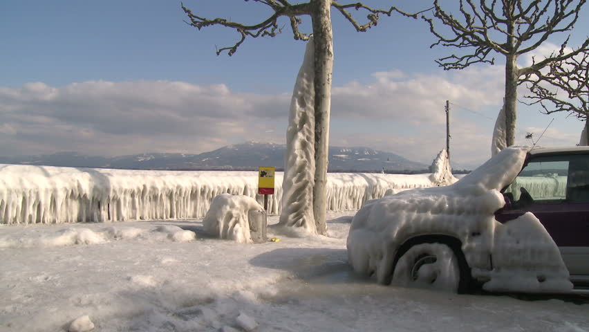 Extreme Ice Storm Coats Car In Thick Ice. Thick ice coats the shore of Lake