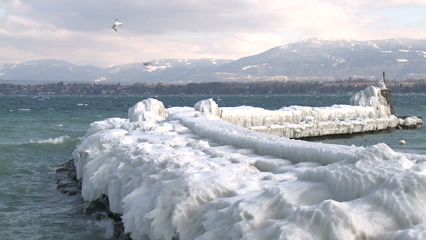 Extreme Ice Storm Hits Lake Shore. Thick ice coats the shore of Lake Geneva