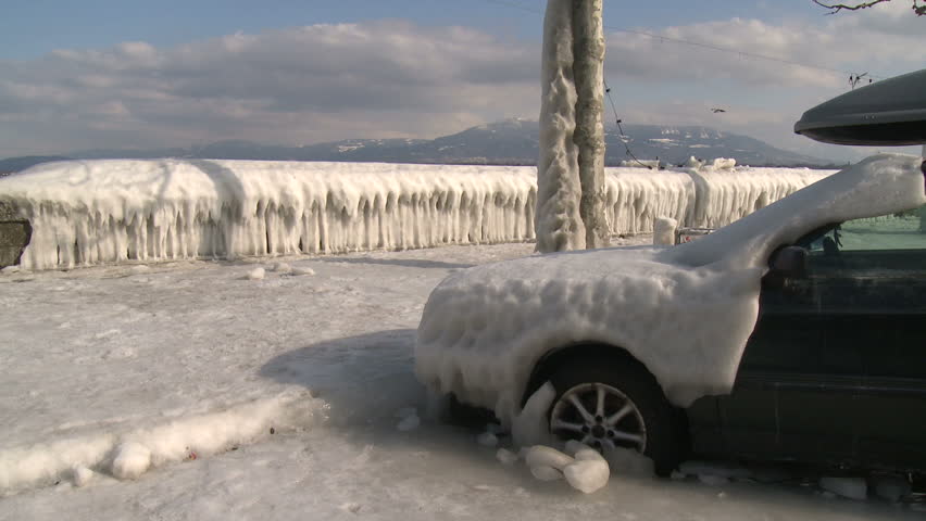 Extreme Ice Storm Coats Car In Thick Ice. Thick ice coats the shore of Lake