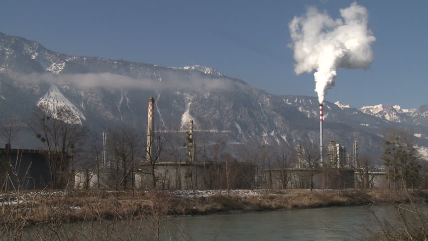 Chimney Pollution With Mountain Background. Shot in full HD 1920x1080 30p on
