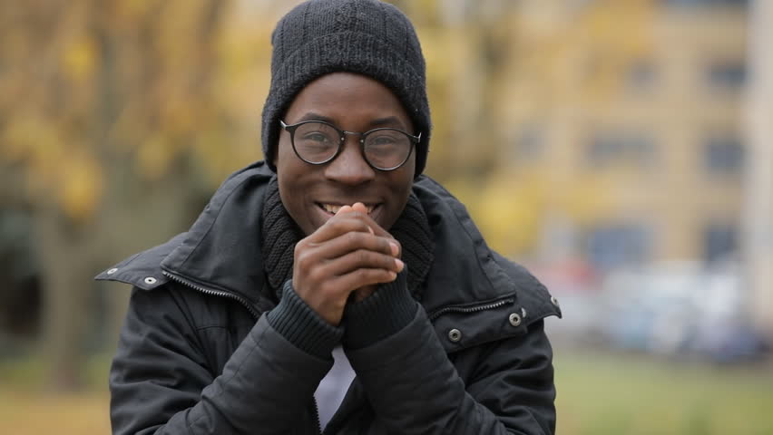 Two thumbs up gesture of african man in hat, cold autumn Royalty-Free Stock Footage #32374735