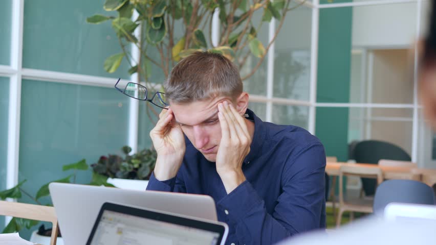 Young Tired Businessman Having Headache in the Office. 4K. | Shutterstock HD Video #32375350