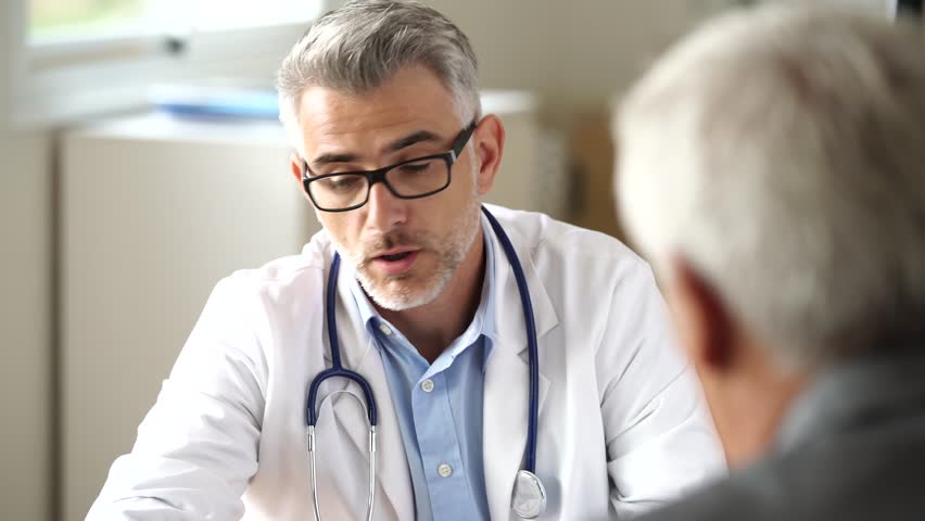 Doctor talking to patient in office Royalty-Free Stock Footage #32376916