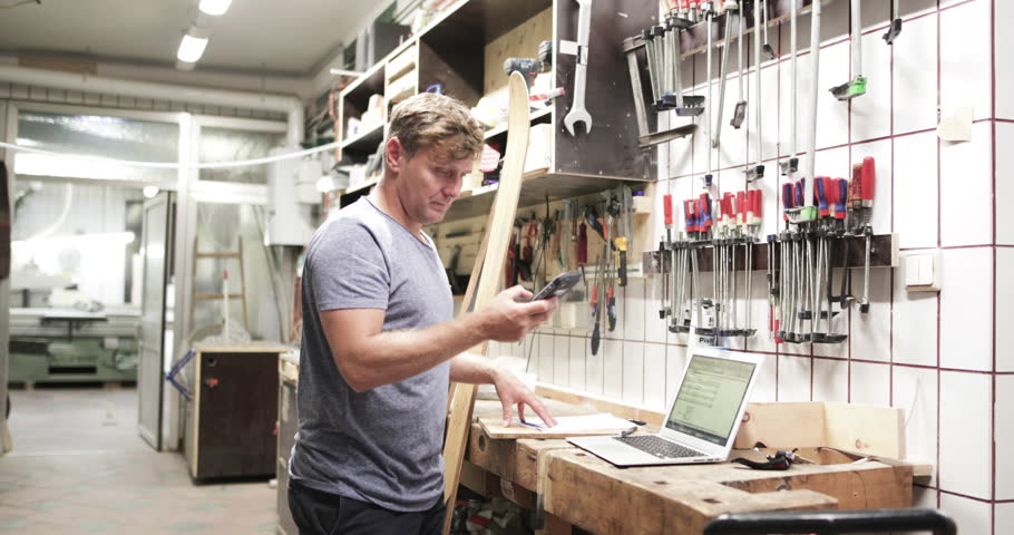 Owner making phone call in workshop