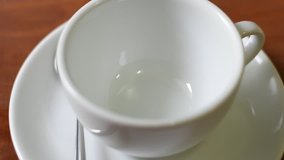 Pouring coffee into a cup.