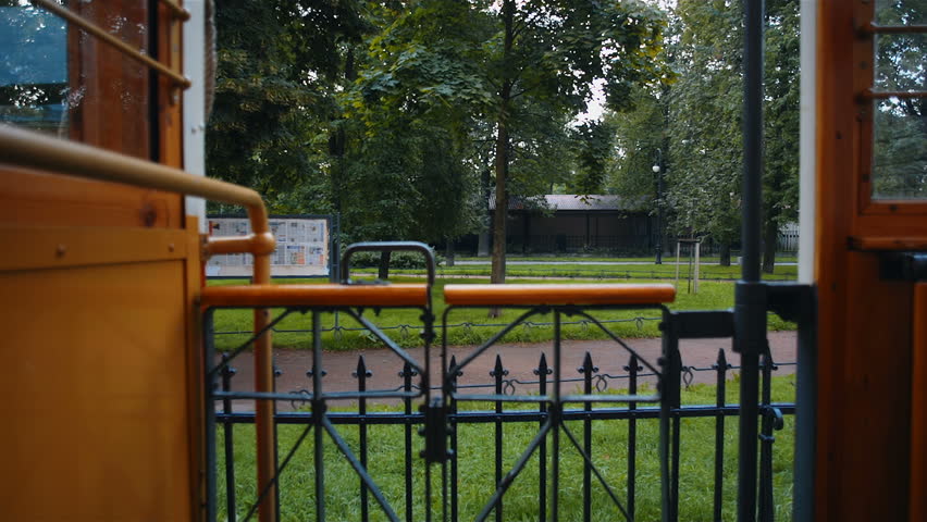 Old man going to enter retro city tram