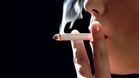 Beautiful woman Smoking a cigarette- extreme close up