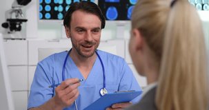 Hospital Doctor Man Write on Clipboard Cheerful Conversation with Patient Woman