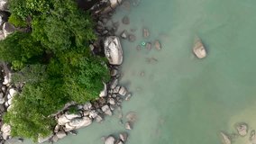 Top Down view aerial video/footage of beauty nature landscape with beach, rocks and sea at Batu Feringghi Penang