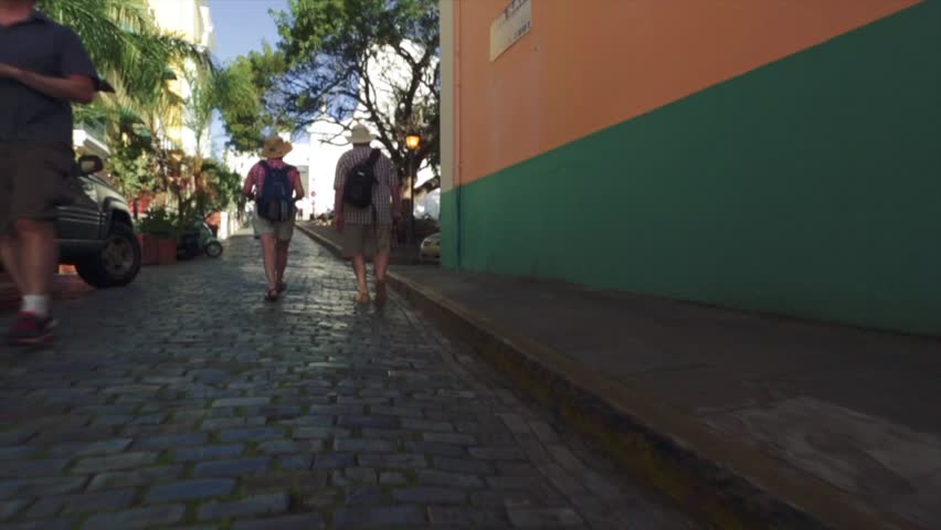 Slow motion of two tourists walking in Old San Juan, Puerto Rico