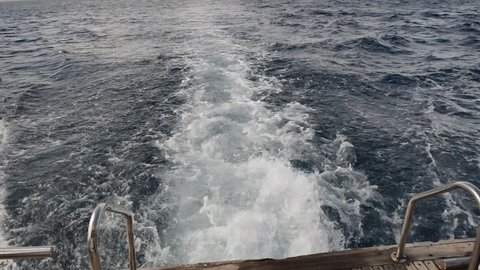 View of the wake behind a moving motor yacht