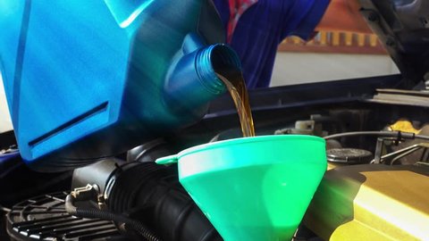 Cinemagraph looping of pouring motor oil in to a engine.
