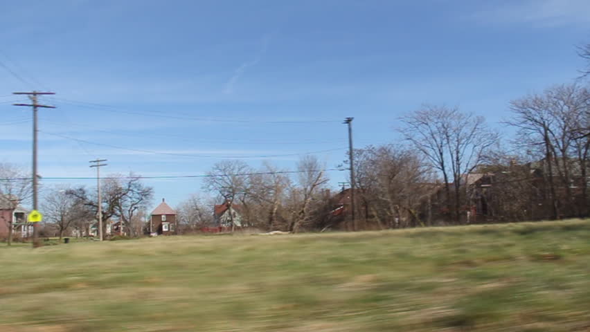Driving through an economically depressed neighborhood of Detroit, Michigan. Many houses boarded up and abandoned, some still occupied but very run down. 
