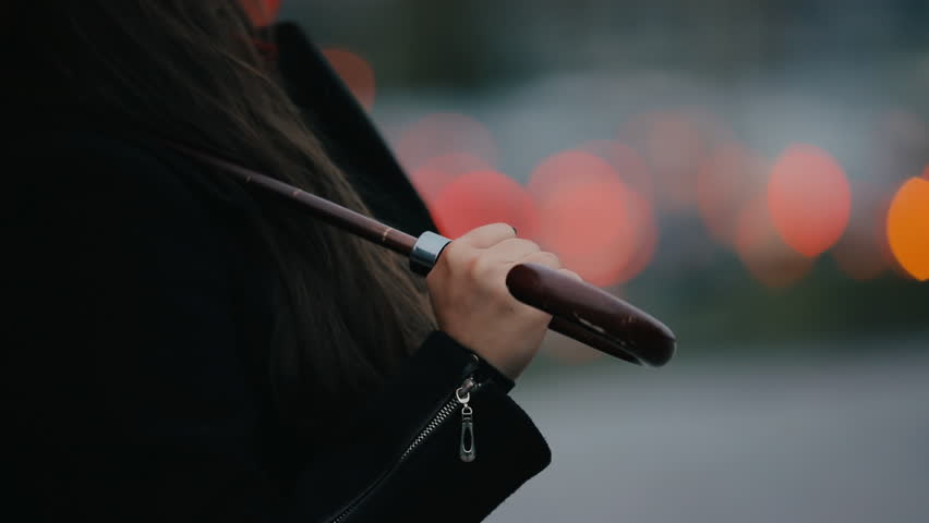 Happy woman under red umbrella looking up to sky