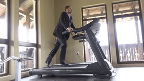 Man with suit running on gym machine, work break, running to success - Powered by Shutterstock - Get 15% off with code: PIKWIZARD15