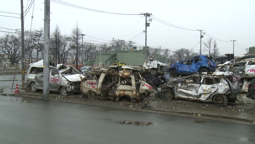 Japan Tsunami 1 Year On - Wrecked Cars. Stacks of wrecked and destroyed cars lie