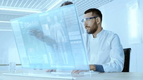 In the Futuristic Laboratory Male and Female Scientists Work on Transparent Computer Display, They Try to Prolong Human Life. Screen Shows Various Human Related Infographics and Data. - Powered by Shutterstock - Get 15% off with code: PIKWIZARD15