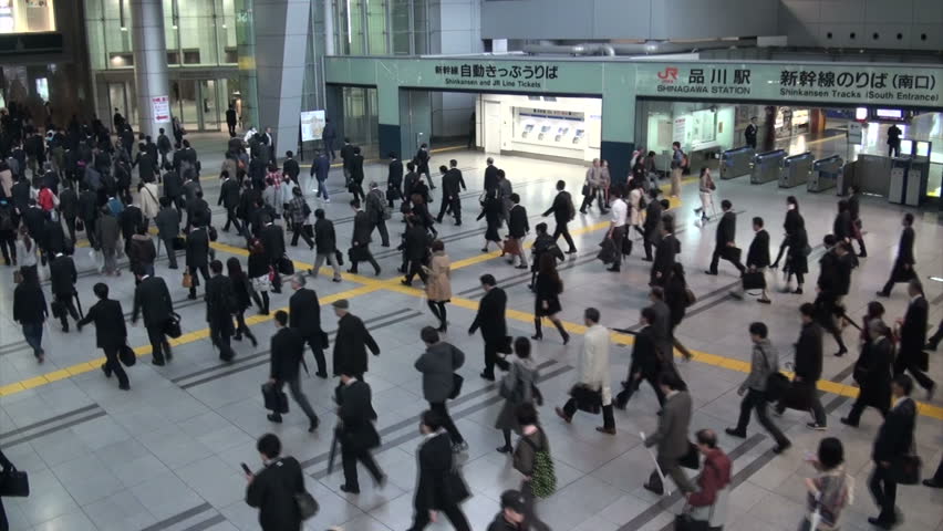 TOKYO, JAPAN - 6 NOVEMBER 2012: City commuters walk through the Shinagawa train station, a major transportation hub in Tokyo, Japan