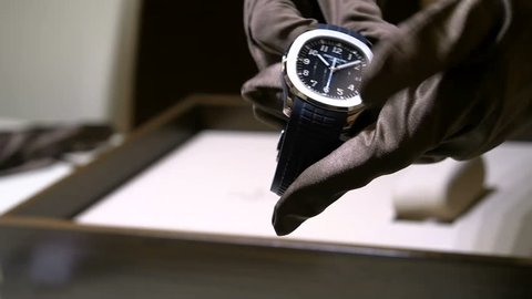 BASEL – MARCH 22: Horologist cleaning watch at Patek Philippe booth at the watches and jewelry show Baselworld in Basel, Switzerland
