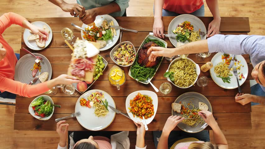 Eating and leisure concept - group of people having dinner at table with food | Shutterstock HD Video #32420230