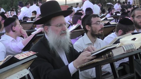 A Rabbi studying the Talmud with his students outside military Prison 6, protesting after some students were arrested for failing to report to military authorities, Atlit Israel, OCT 25, 2017
