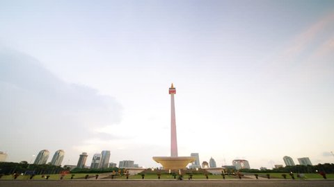 JAKARTA, Indonesia. October 30, 2017: Day to night timelapse of Monas or National Monument with moving clouds at sunset time. A historical landmark placed in Jakarta, Indonesia
